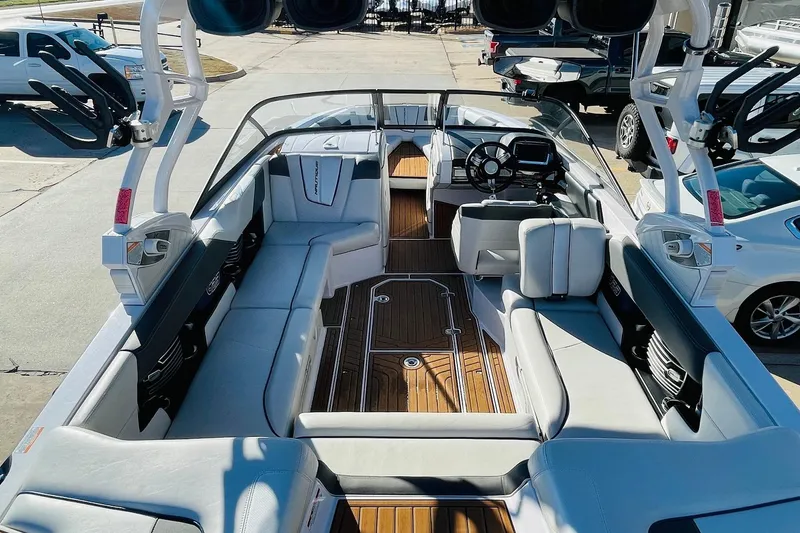 Slide: The Image of 2015 Nautique Super Air Nautique G23 boat interior with seating and steering wheel. - 7