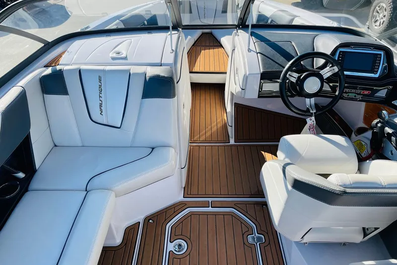 Slide: The Image of 2015 Nautique Super Air Nautique G23 interior with sleek seating and modern dashboard. - 8