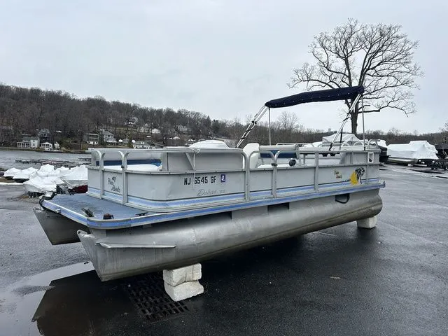 Slide: The Image of 1998 Palm Beach 200 pontoon boat on a parking lot. - 11