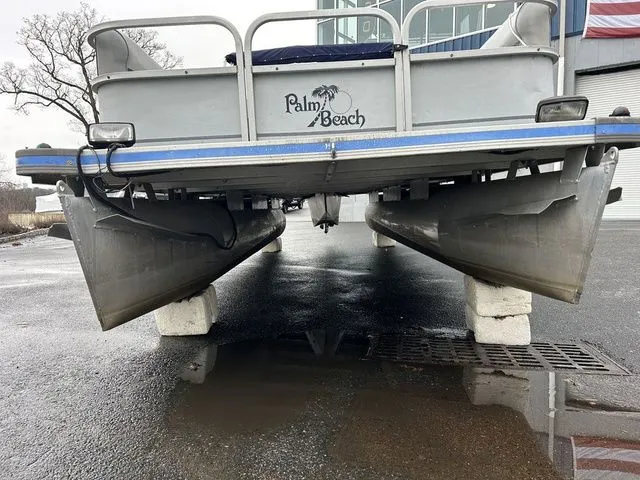 Slide: The Image of 1998 Palm Beach 200 pontoon boat elevated on concrete blocks. - 13