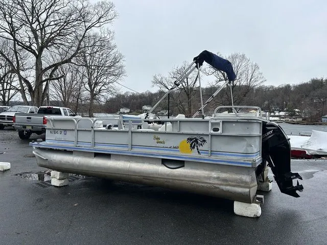 Slide: The Image of 1998 Palm Beach 200 pontoon boat parked on a lot. - 14