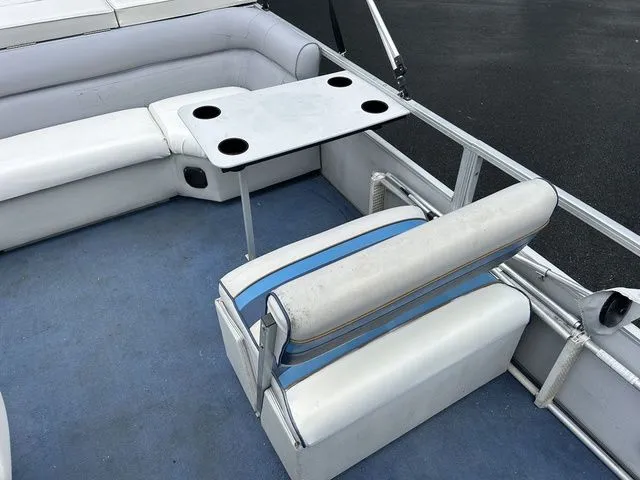 Slide: The Image of Interior of a 1998 Palm Beach 200 pontoon boat with seating and table. - 4