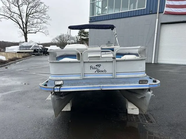 Slide: The Image of 1998 Palm Beach 200 pontoon boat in front of a building. - 6