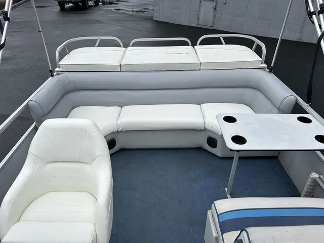 Slide: The Image of Interior of a 1998 Palm Beach 200 pontoon boat with white seating. - 7