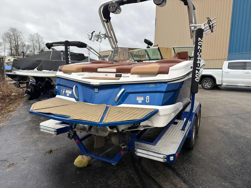 Slide: The Image of 2018 MasterCraft XT 20 boat on trailer, blue and white. - 2