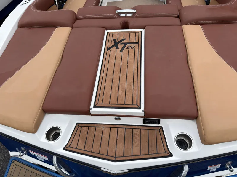 Slide: The Image of 2018 MasterCraft XT 20 boat stern with brown upholstery. - 3