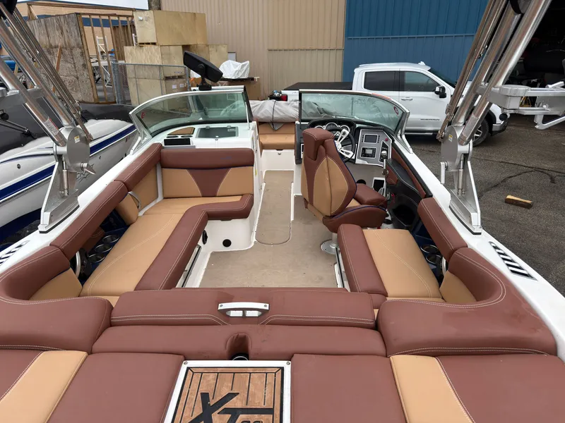 Slide: The Image of Interior of a 2018 MasterCraft XT 20 boat with brown leather seating. - 4