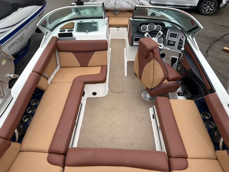 Slide: The Image of Interior of a 2018 MasterCraft XT 20 boat with brown leather seats. - 5