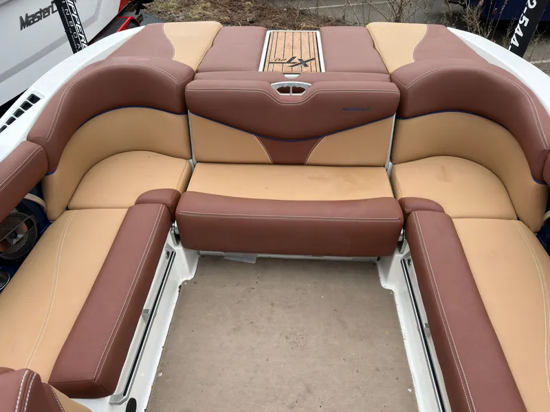 Slide: The Image of Interior of a 2018 MasterCraft XT 20 boat with brown seating. - 6
