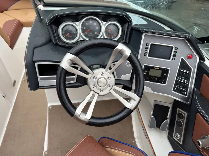 Slide: The Image of Interior view of 2018 MasterCraft XT 20 boat cockpit with steering wheel and dashboard. - 9