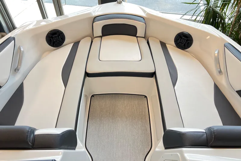 Slide: The Image of 2024 Yamaha Boats AR195 interior with cushioned seating and built-in speakers. - 7