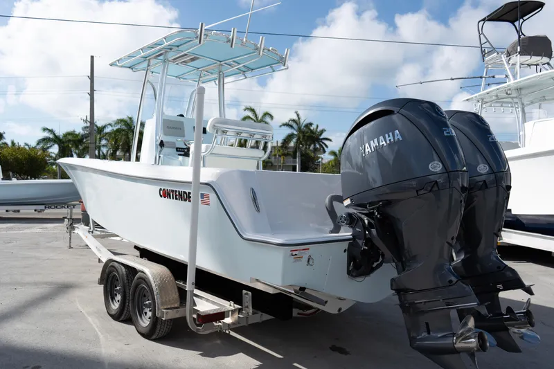 Slide: The Image of 2024 Contender 25 Tournament boat with dual Yamaha engines on a trailer. - 12