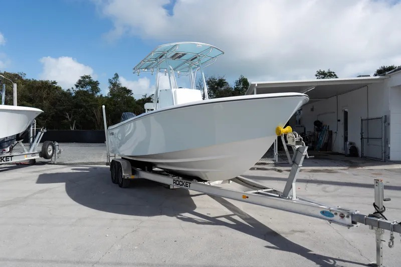 Slide: The Image of 2024 Contender 25 Tournament boat on trailer, parked outdoors under a cloudy sky. - 2