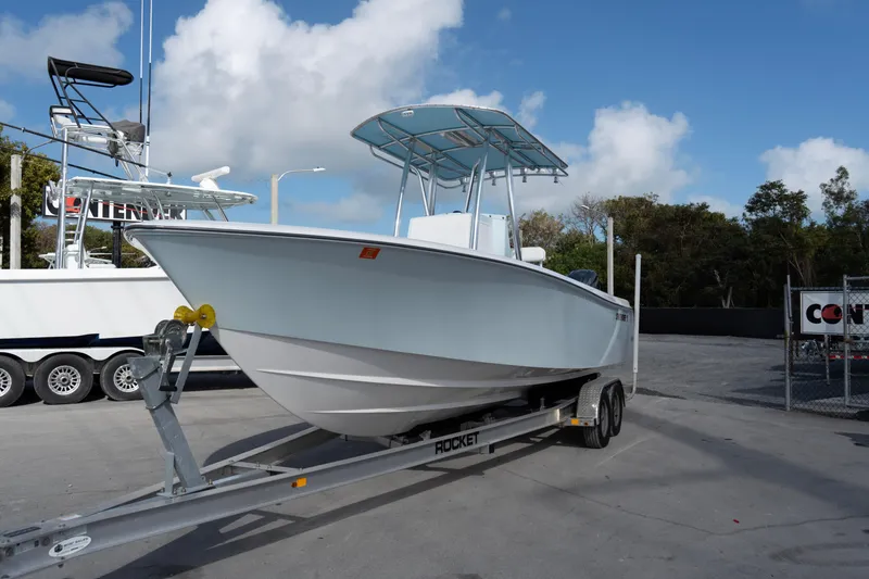 Slide: The Image of 2024 Contender 25 Tournament boat on trailer under blue sky. - 3