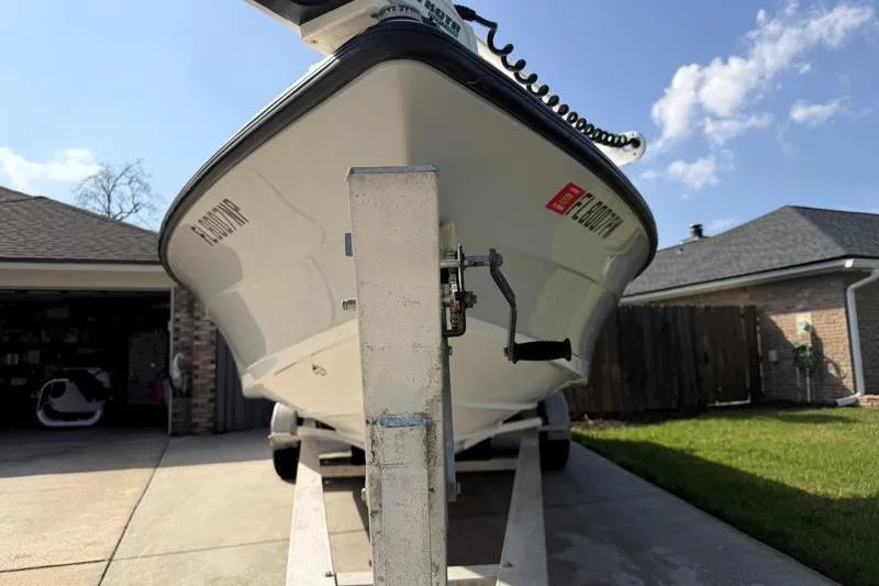 Slide: The Image of 2012 Edgewater 240 Inshore boat on trailer in driveway, sunny day. - 13
