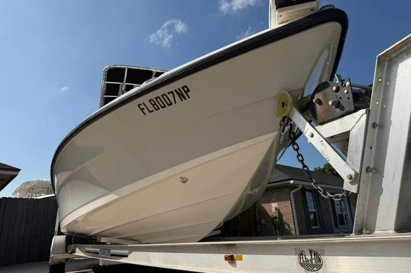 Slide: The Image of 2012 Edgewater 240 Inshore boat on trailer, sunny day, registration FL8007WP. - 14