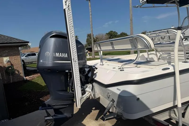 Slide: The Image of 2012 Edgewater 240 Inshore boat with Yamaha outboard motor, parked on a trailer. - 16
