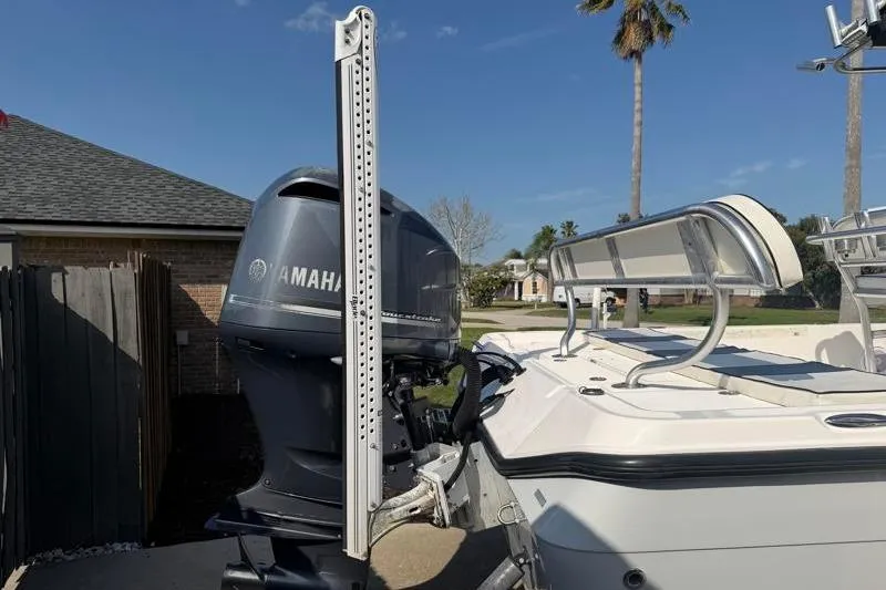 Slide: The Image of 2012 Edgewater 240 Inshore boat with Yamaha outboard motor, parked outdoors. - 20
