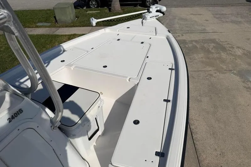 Slide: The Image of 2012 Edgewater 240 Inshore boat deck with storage compartments and trolling motor. - 28