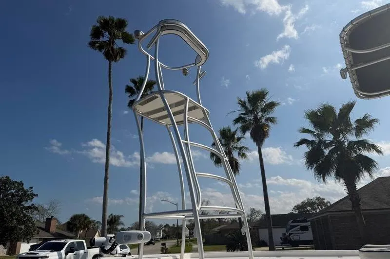 Slide: The Image of Tower on 2012 Edgewater 240 Inshore boat under clear blue sky with palm trees. - 3
