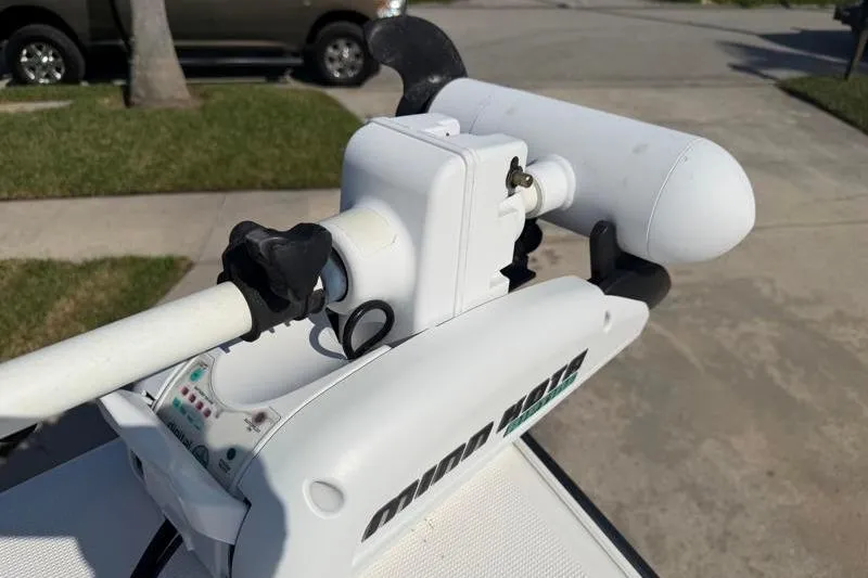 Slide: The Image of Minn Kota trolling motor on a 2012 Edgewater 240 Inshore boat, parked outdoors. - 30