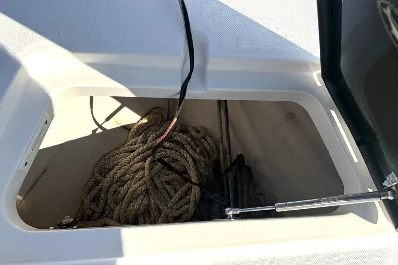 Slide: The Image of Storage compartment with rope and anchor on 2012 Edgewater 240 Inshore boat. - 33