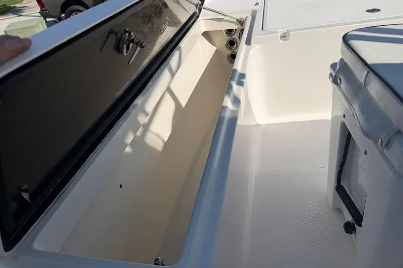 Slide: The Image of Open storage compartment on a 2012 Edgewater 240 Inshore boat, showcasing interior space. - 36