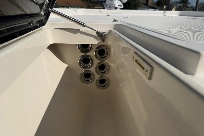 Slide: The Image of Interior view of a 2012 Edgewater 240 Inshore boat, showcasing rod holders. - 37