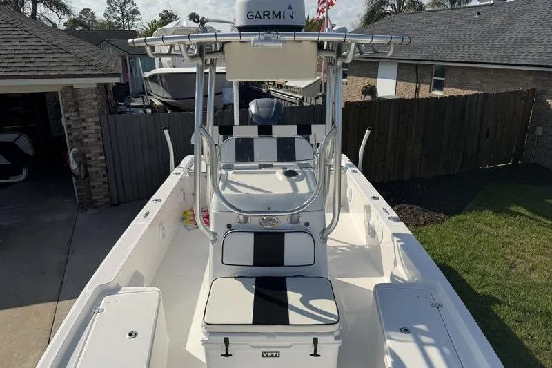Slide: The Image of 2012 Edgewater 240 Inshore boat with Garmin equipment, parked in a residential driveway. - 41