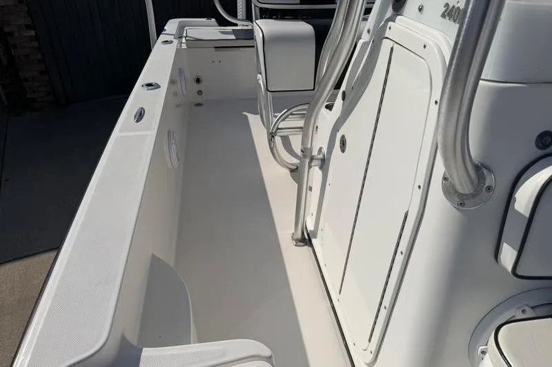 Slide: The Image of 2012 Edgewater 240 Inshore boat interior with seating and storage compartments. - 45