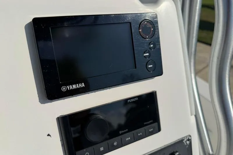 Slide: The Image of Yamaha and Fusion control panels on 2012 Edgewater 240 Inshore boat dashboard. - 57