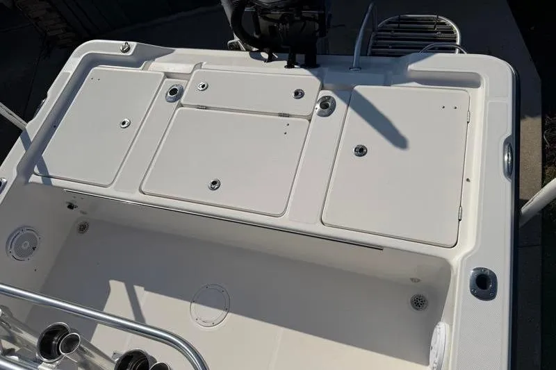 Slide: The Image of 2012 Edgewater 240 Inshore boat deck with storage compartments and fishing rod holders. - 63