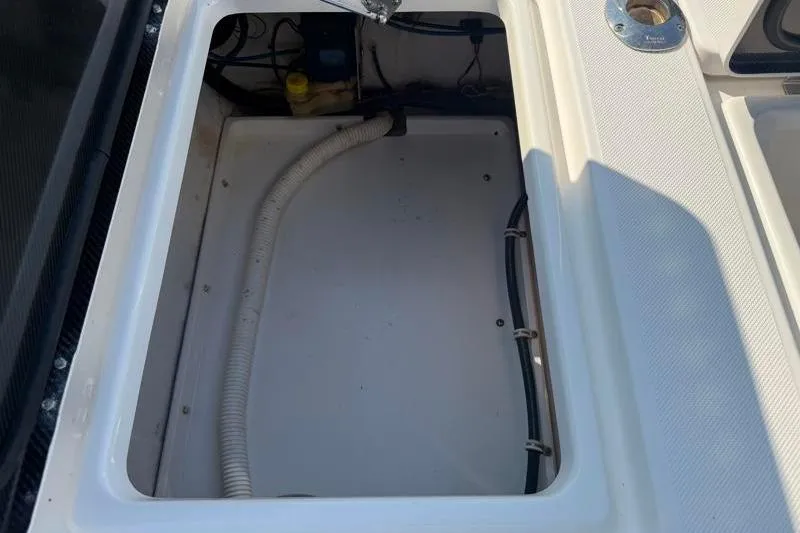 Slide: The Image of Open storage compartment on a 2012 Edgewater 240 Inshore boat, showing interior details. - 65