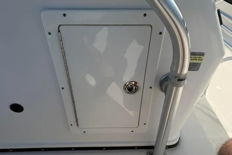 Slide: The Image of Edgewater 240 Inshore 2012 boat compartment with stainless steel handle and latch. - 74