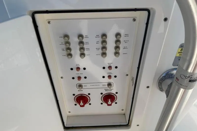 Slide: The Image of Control panel of a 2012 Edgewater 240 Inshore boat with switches and dials. - 75