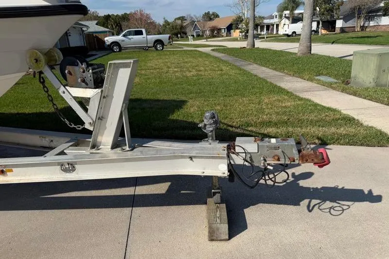 Slide: The Image of Trailer for 2012 Edgewater 240 Inshore boat parked on suburban street. - 78