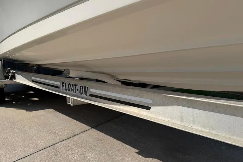 Slide: The Image of Edgewater 240 Inshore 2012 boat on a "Float-On" trailer, side view. - 79