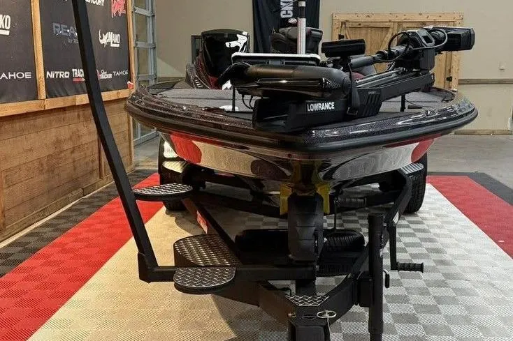 Slide: The Image of 2026 Triton 20XP Patriot boat on display with advanced Lowrance equipment. - 13
