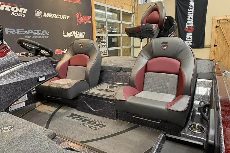 Slide: The Image of 2026 Triton 20XP Patriot boat interior with stylish seating and steering wheel. - 3