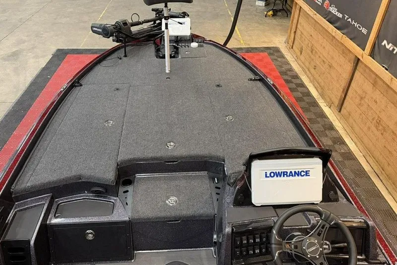 Slide: The Image of 2026 Triton 20XP Patriot boat interior with Lowrance electronics and steering wheel. - 6