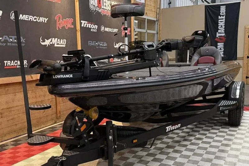 Slide: The Image of 2026 Triton 20XP Patriot boat on display with Lowrance equipment. - 9