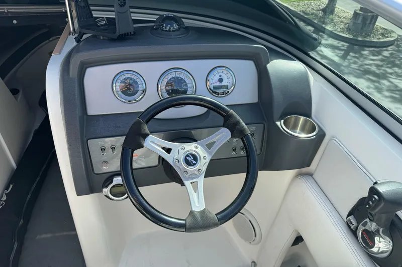 Slide: The Image of Steering console of a 2012 Sea Ray 240 Sundeck boat with gauges and controls. - 14