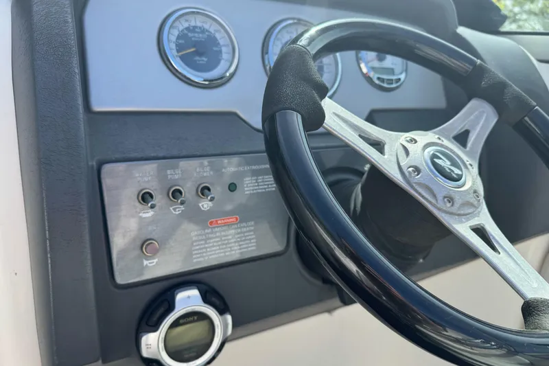 Slide: The Image of Steering wheel and dashboard of 2012 Sea Ray 240 Sundeck boat. - 15