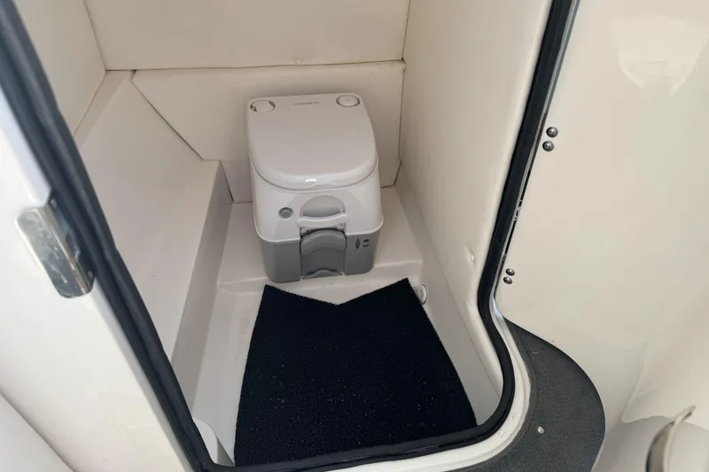 Slide: The Image of Interior of 2012 Sea Ray 240 Sundeck showing compact marine toilet. - 16