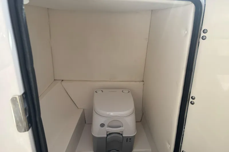 Slide: The Image of Portable toilet inside 2012 Sea Ray 240 Sundeck boat compartment. - 17