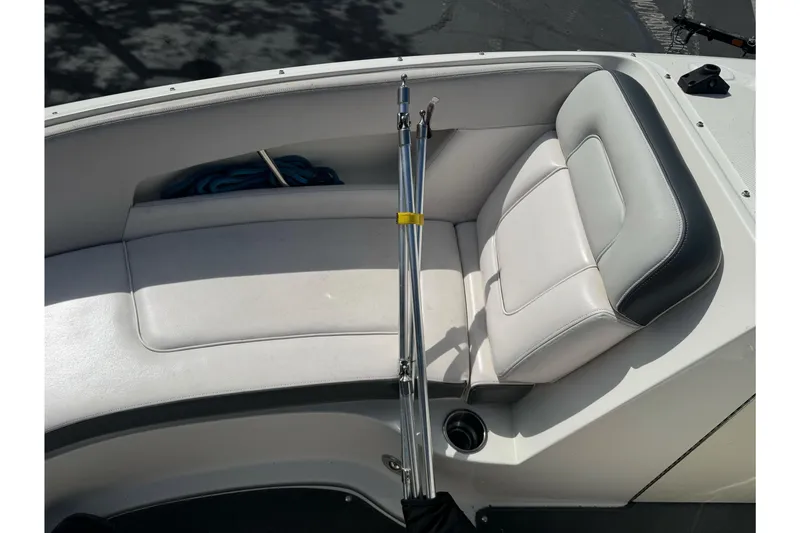 Slide: The Image of 2012 Sea Ray 240 Sundeck boat interior with white seating and metal poles. - 19