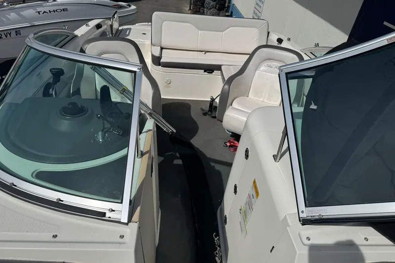 Slide: The Image of 2012 Sea Ray 240 Sundeck interior with seating and dashboard view. - 21