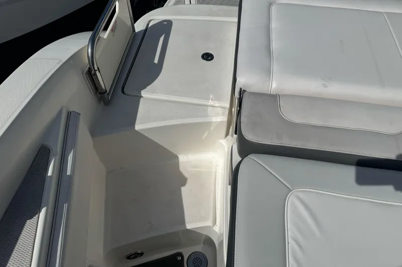 Slide: The Image of 2012 Sea Ray 240 Sundeck interior seating and storage area. - 7