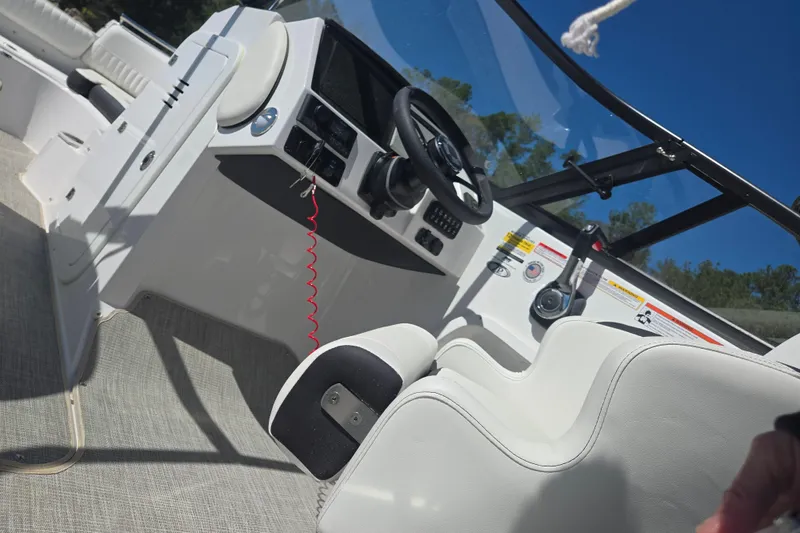Slide: The Image of Interior view of 2026 Stingray 231 DC boat cockpit with steering wheel and controls. - 4
