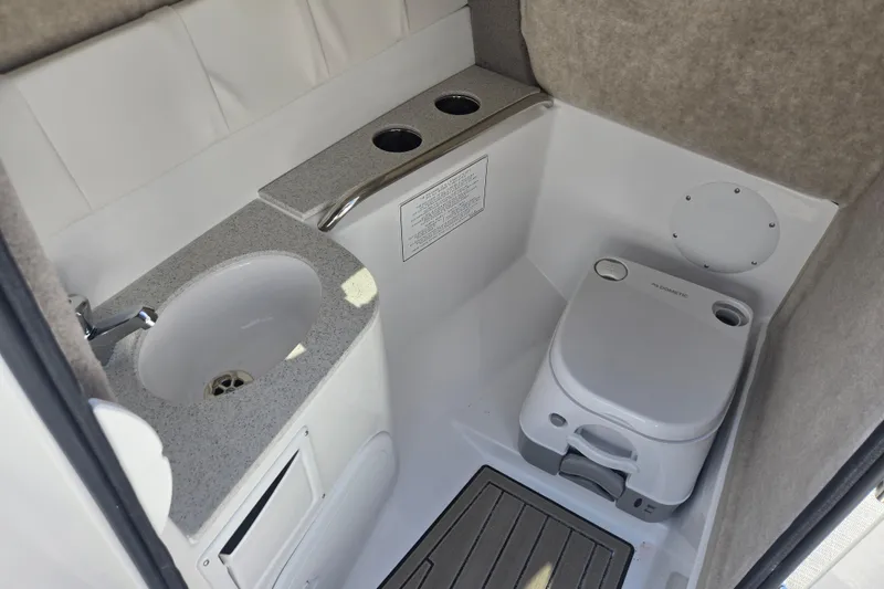 Slide: The Image of 2026 Stingray 231 DC boat interior with sink and portable toilet. - 6